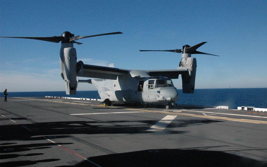 An MV-22 Osprey troops transport aircraft on the flight deck of the USS America off the coast of California.

