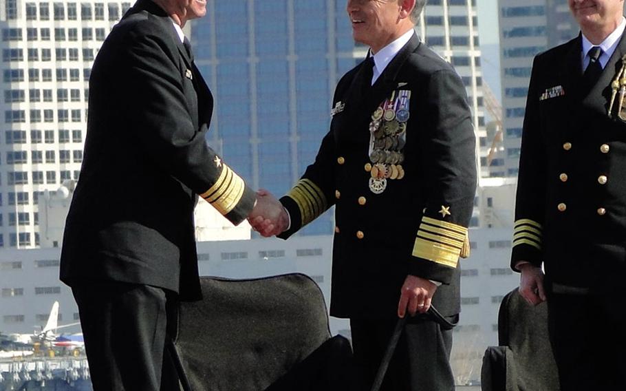 Vice Adm. David Buss (left) shakes hands with Adm. Harry Harris Jr., commander of U.S. Pacific Fleet, at Buss' change of command and retirement ceremony Jan. 22, 2015, aboard the USS John C. Stennis at Naval Station North Island, California. 