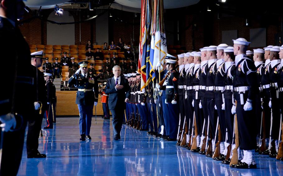 Defense Secretary Chuck Hagel, center, and Col. Johnny Davis, commander of the 3rd Infantry Regiment, render honors during Hagel's farewell tribute at Conmy Hall on Joint Base Myer-Henderson Hall in Arlington, Va., on Jan. 28, 2015.