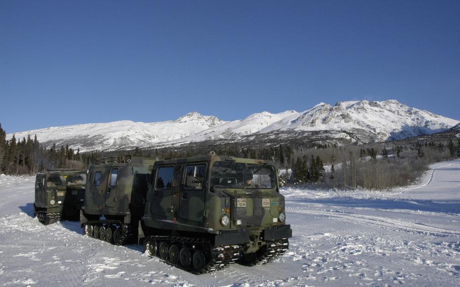 Small Unit Support Vehicles wait to transport personnel at the Black Rapids Training Site, Alaska, on Feb. 9, 2015. Units from 12 different countries are conducting cold-weather training in the Alaskan wilderness this week. 

