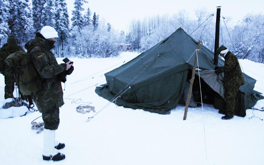 German and Japanese soldiers inspect a tent at Black Rapids Training Site, Alaska, on Feb. 10, 2015. Troops from 12 nations are spending time in the remote Alaska wilderness this week to conduct cold-weather training.


Seth Robson/Stars and Stripes