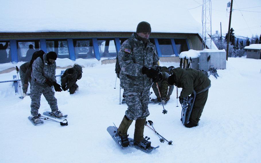 Soldiers prepare to march in snow shoes at Black Rapids Training Site, Alaska, on Feb. 10, 2015. 

