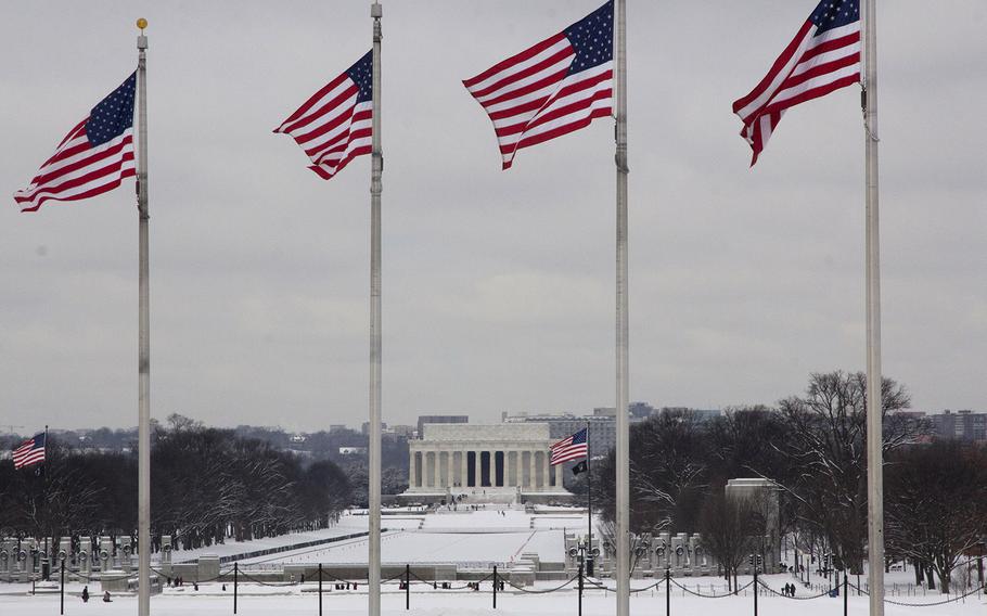 Flags at the Washington Monument, with the National World War II Memorial and the Lincoln Memorial in the background, Feb. 17, 2015.