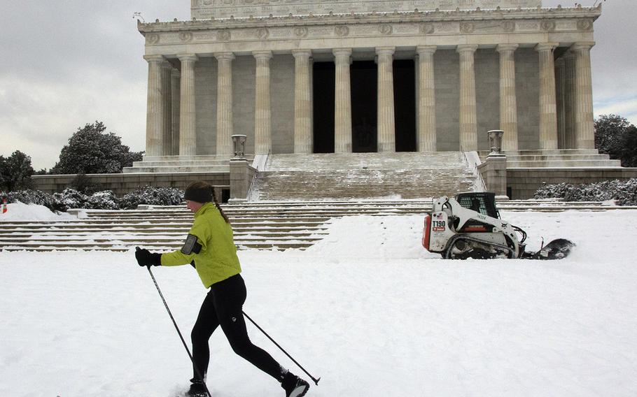 Skiing and snow removal coexist at the Lincoln Memorial in Washington, D.C., Feb. 17, 2015.
