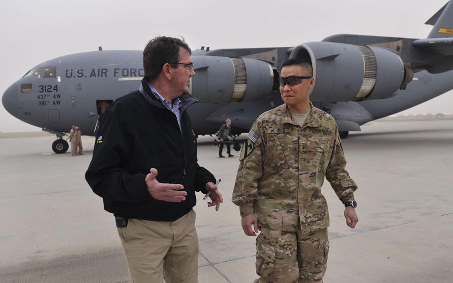 Secretary of Defense Ash Carter is greeted by Brig. Gen. Viet Luong, commander of Train, Assist, Advise Command, south, as Carter arrives at Kandahar Air Field, Afghanistan, on Sunday, Feb. 22, 2015.