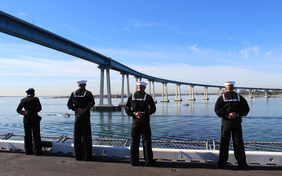 Sailors man the rails Wednesday morning as the USS Makin Island passes under the San Diego-Coronado Bridge on its way back to Naval Base San Diego, Calif. after a seven-month deployment.