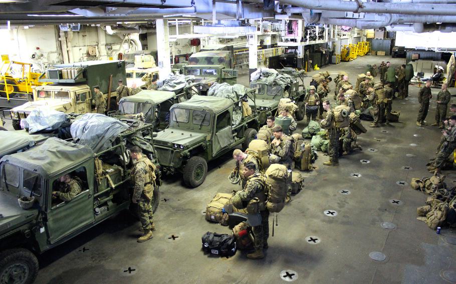 Marines with Battalion Landing Team 2nd Battalion, 1st Marine Regiment, 11th Marine Expeditionary Unit, prepare to load their vehicles onto a landing craft air cushion to return to Camp Pendleton, Calif., from the USS Makin Island. The unit was deployed on the ships of the Makin Island Amphibious Ready Group for seven months. Photo by 