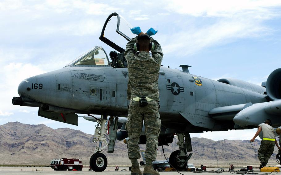 An Air Force crew chief watches as an A-10 Thunderbolt taxis into position after landing May 9, 2013, at Nellis Air Force Base, Nev. 