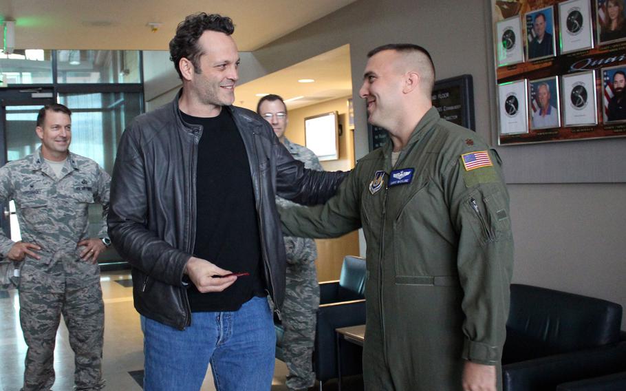 Actor Vince Vaughn accepts a patch with the Average Joe's logo from Vaughn's movie, "Dodgeball," from an airman Saturday at Edwards Air Force Base, Calif. Vaughn visited the base as part of a USO tour, his third.