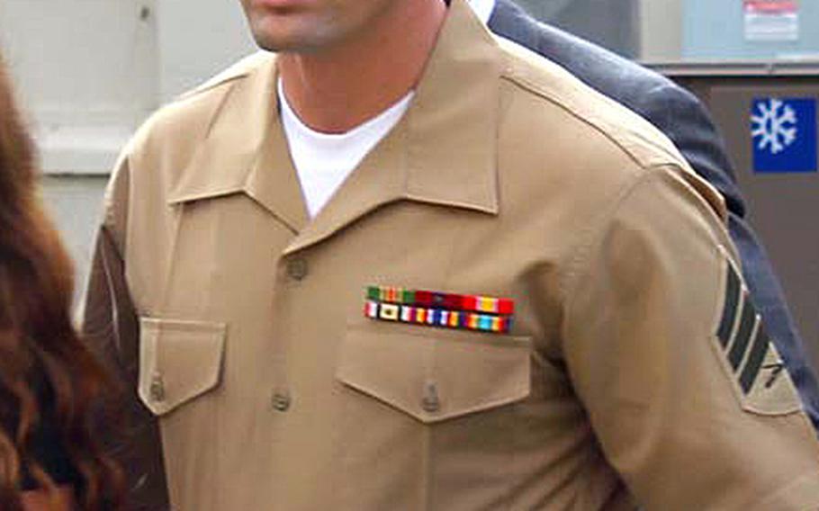 Sgt. Lawrence G. Hutchins III walks to a court room for a hearing at Camp Pendleton, Calif., on Aug. 14, 2014.