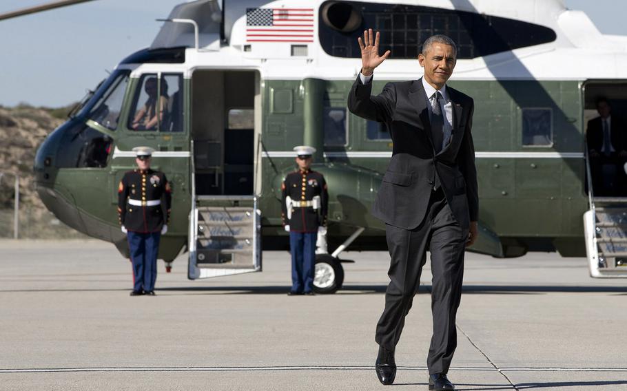 President Barack Obama waves as walks to board Air Force One on departure from Los Angeles International Airport, on March 13, 2015, en route to Phoenix. 