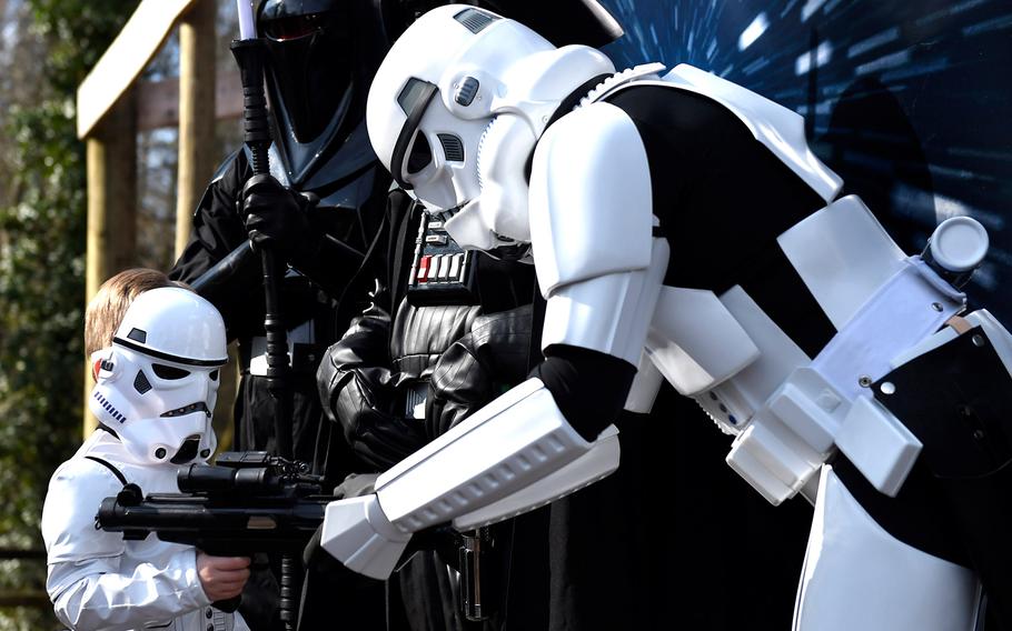 Grant Tunnell, 5, left, dressed as a mini-Stormtrooper, borrows a blaster rifle from a grown-up Stormtrooper on Star Wars Character Day at the Knoxville Zoo on March 21, 2015, in Knoxville, Tenn. Grant visited with parents Steve and Heather of Greenville, Tenn. on a day when the zoo offered free admission to children dressed as Star Wars characters. 
