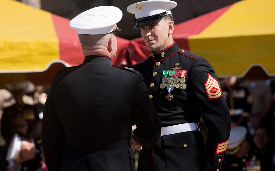 Maj. Gen. Joseph L. Osterman presents Gunnery Sgt. Brian C. Jacklin, right, with the Navy Cross during a ceremony Thursday, April 9, 2015, to honor Jacklin and 5 other members of Marine Special Operations Team 8131 at Camp Pendleton, Calif.