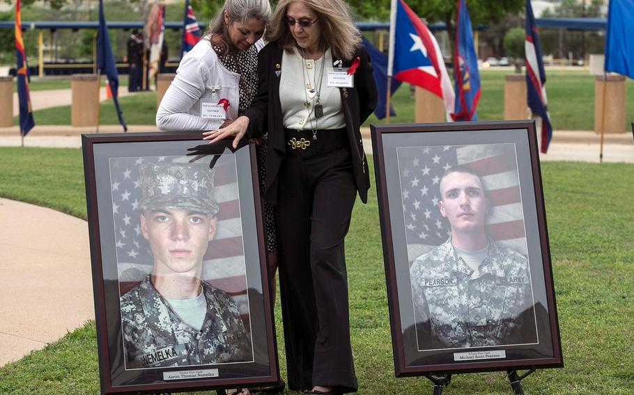 Teena Nemelka, left, mother of Pfc. Aaron Nemelka, left picture, and Sheryll Pearson, right, mother of Pfc. Michael Pearson, right picture, visit one another, on April 10, 2015, at Fort Hood, Texas, before receiving the Purple Heart for their sons who were killed during the attack.