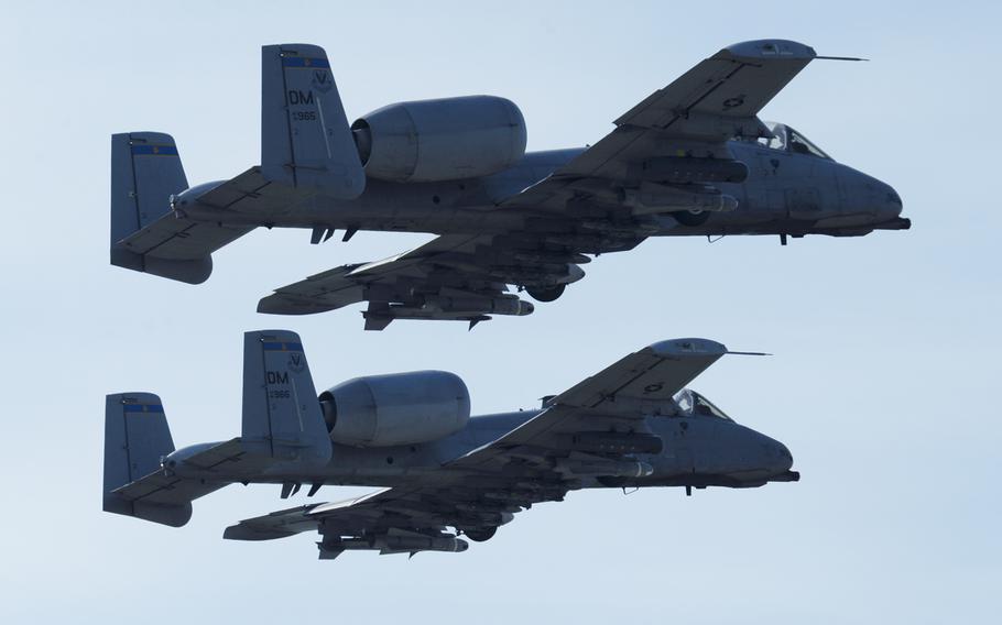 Two U.S. Air Force A-10 Thunderbolt II aircraft assigned to the 354th Expeditionary Fighter Squadron take off from a runway during deployment at Campia Turzii, Romania, April 14, 2015. 