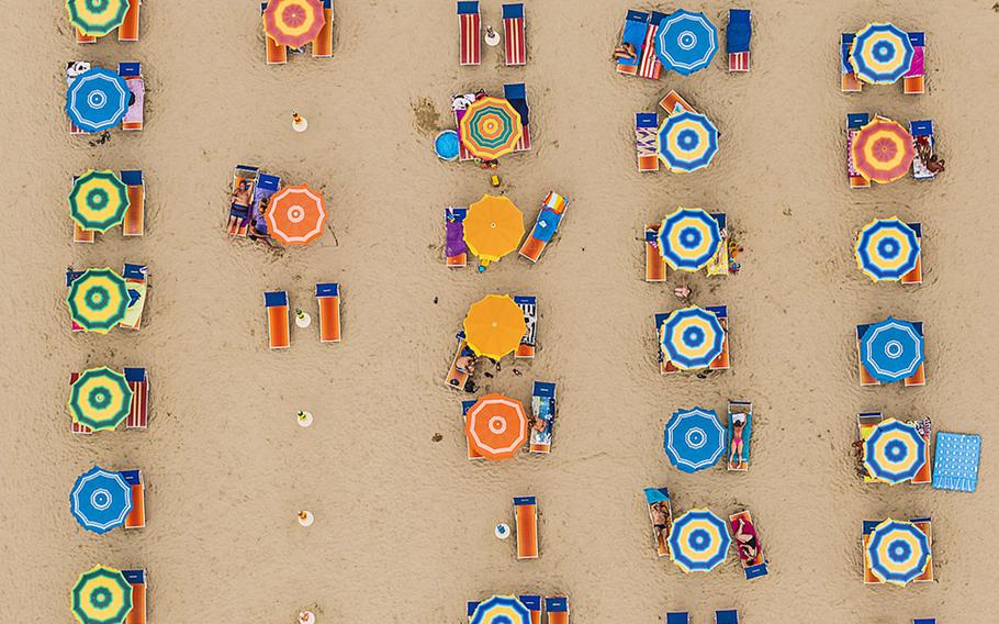 Bernhard Lang, Travel Photographer of the Year | Aerial photographs of the Adriatic coastline between Ravenna and Rimini, Italy. Photographed in August 2014. As thousands of sun worshipers lazed on the golden sands, sheltering underneath massive beach umbrellas, photographer Bernhard Lang took these photographs.