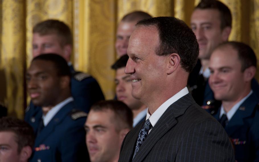 The Air Force Academy football team coach Troy Calhoun smiles during a White House ceremony in which President Barack Obama presented the Commander-in-Chief's Trophy to the team on May 7, 2015. The Air Force Falcons defeated the Army team 23-6 in November to win the trophy.