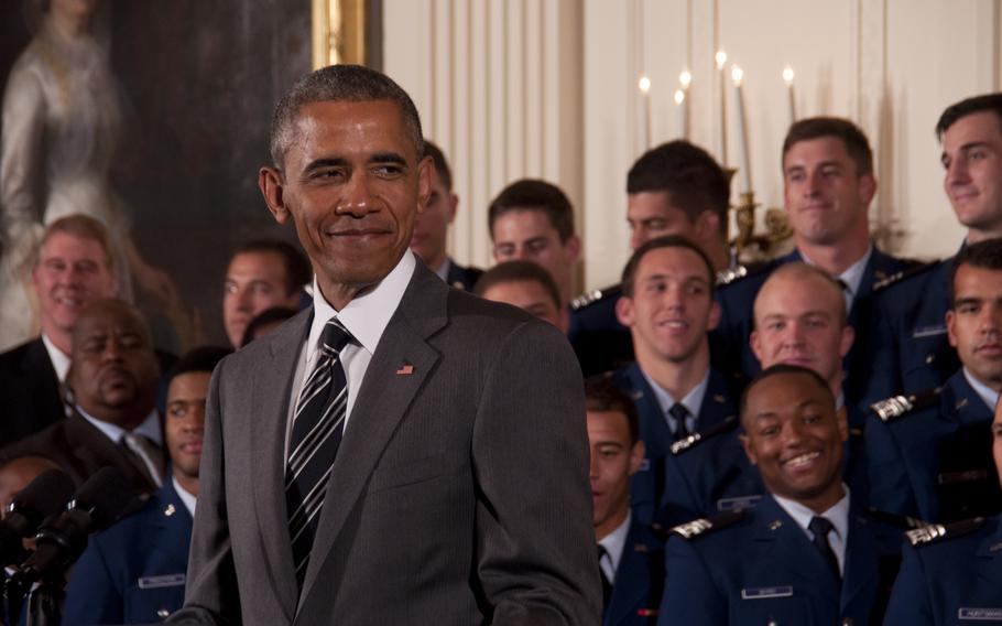 President Barack Obama presents the Commander-in-Chief's Trophy to the U.S. Air Force Academy football team at the White House on May 7, 2015. The Air Force Falcons defeated the Army team 23-6 in November to win the trophy.