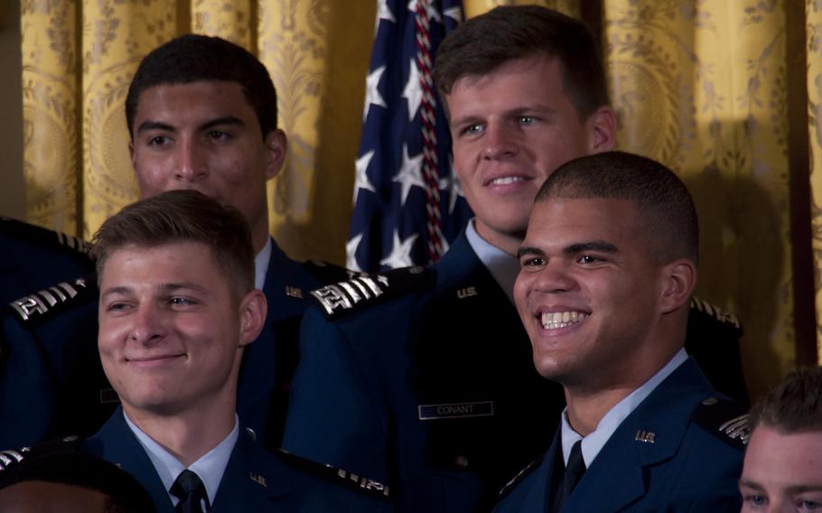 Members of the Air Force Academy Falcons football team smile as President Barack Obama presents the Commander-in-Chief's Trophy at the White House on May 7, 2015. The Falcons defeated the Army team 23-6 in November to win the trophy.