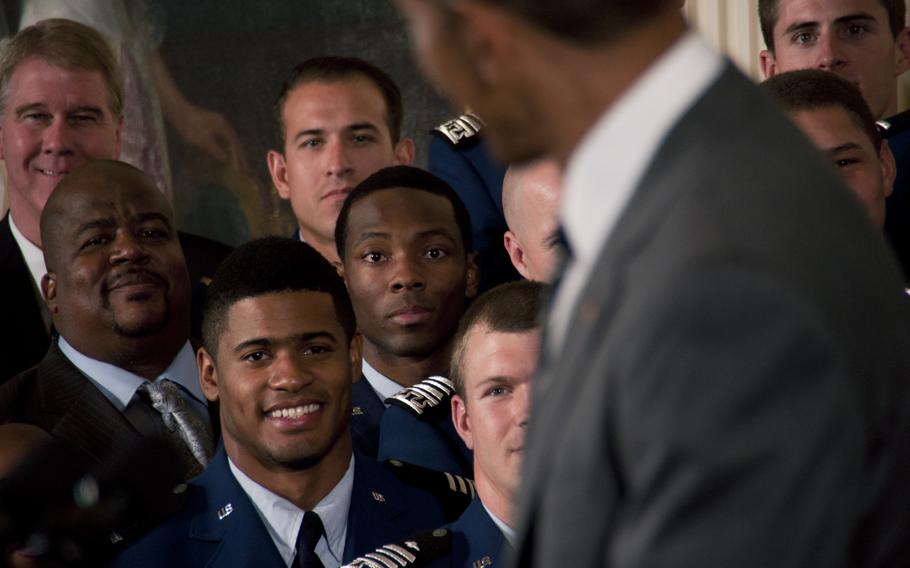 Members of the Air Force Academy Falcons football team smile as President Barack Obama presents the Commander-in-Chief's Trophy at the White House on May 7, 2015. The Falcons defeated the Army team 23-6 in November to win the trophy.