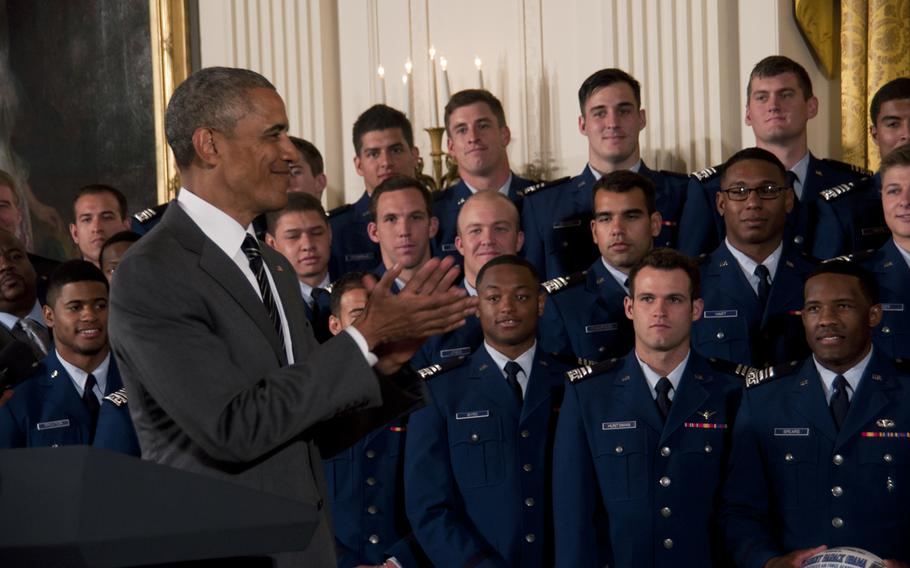 President Barack Obama applauds the U.S. Air Force Academy Falcons football team while presenting them the Commander-in-Chief's Trophy at the White House on May 7, 2015. The Falcons beat the Army team 23-6 in November to win the trophy.