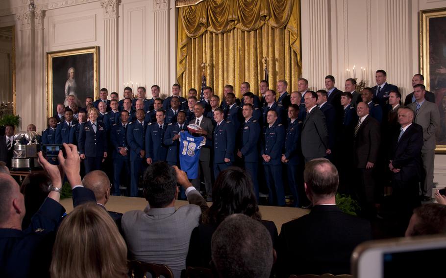 The Air Force Academy football team poses with President Barack Obama and the Commander-in-Chief's Trophy at the White House on May 7, 2015. The Air Force Falcons beat the Army team 23-6 in November to win the trophy.