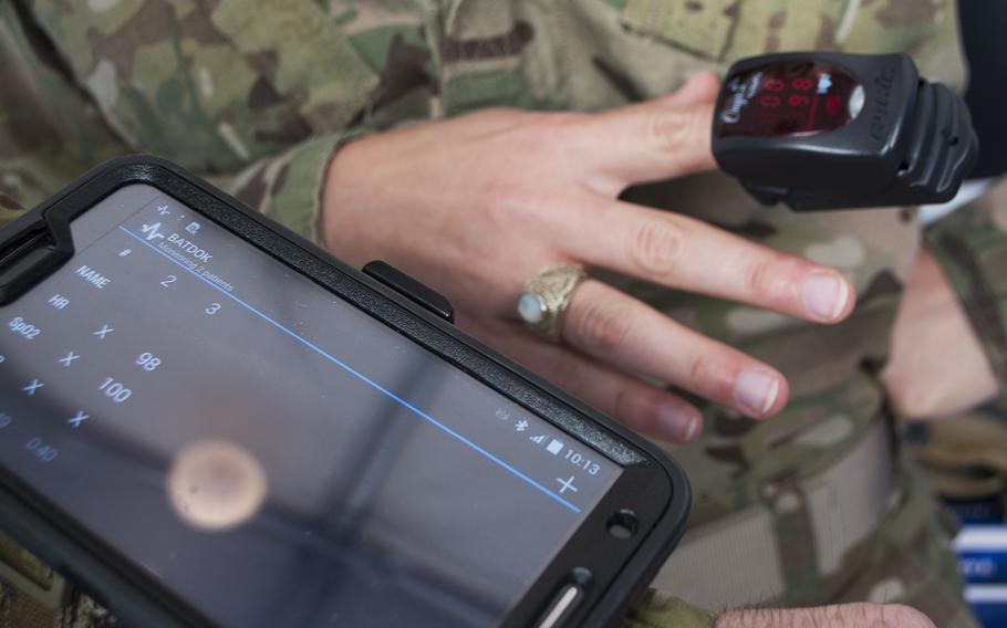 A heart monitor on Lt. Caroline Kurtz's finger workes wirelessly with a device on Lt. Tony Easton's wrist. 