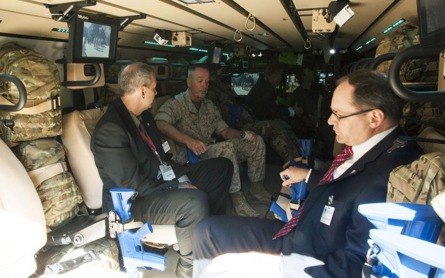 Gen. Joseph Dunford (second from left), commandant of the Marine Corps, sits in a CAMEL - concept for advanced military explosion-mitigating land demonstrater - at DOD Lab Day at the Pentagon on May 14, 2015. The CAMEL is described as “a nontraditional Army Ground Vehicle Survivability Demonstrator, designed and optimized with the latest advancement in armor and protection for the safety and survivability of the occupants.” 