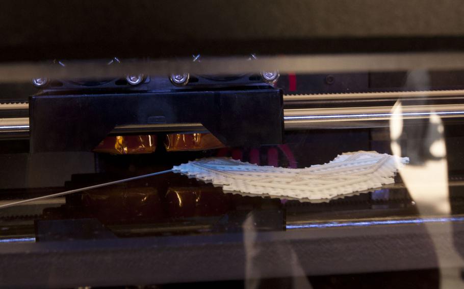 A 3D printer etches out an Air Force logo at DoD Lab Day at the Pentagon on May 14, 2015. The Air Force Research Laboratory is looking at printing wearable technology and adding printed materials to existing hardware.