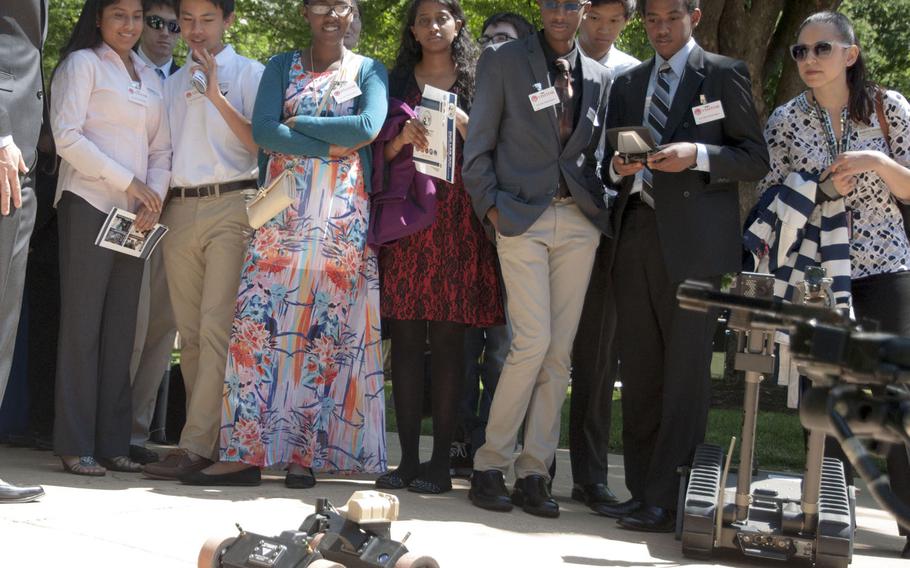 Melak Alemu from Thomas Edison High School in Alexandria, Va., controls a wall-climbing robot at DOD Lab Day at the Pentagon on May 14, 2015.