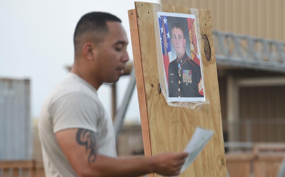 A Combined Joint Task Force-Horn of Africa service member highlights a Medal of Honor recipient during enlisted physical training at Camp Lemonnier, Djibouti, May 15, 2015. In honor of Memorial Day, physical training leaders showcased past and present heros at each PT station.