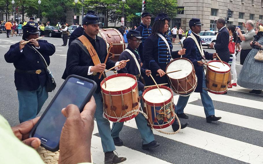 Reenactors march by in Washington, D.C., on Sunday, May 17, 2015.