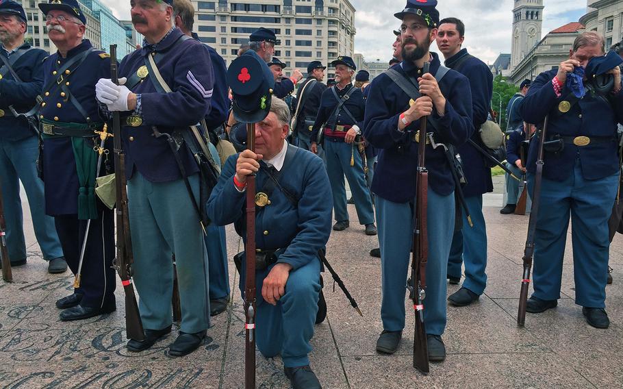 Reenactors take a break after marching in Washington, D.C., on Sunday, May 17, 2015, as part of the Grand Review Parade celebrating its 150 year anniversary.