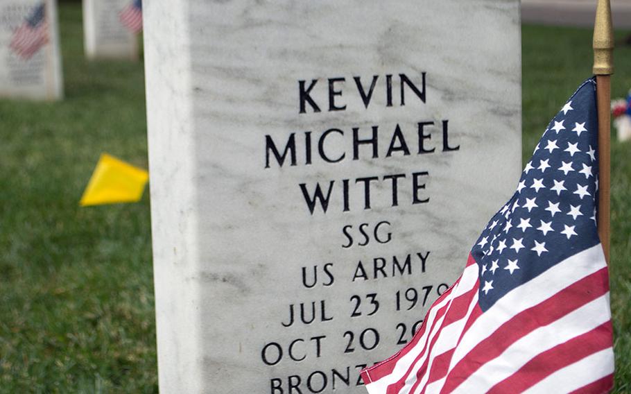 Silver airborne wings rest atop the grave of Staff Sgt. Kevin Michael Witte, placed there by his best friend, Staff Sgt. Oliver Moore, along with the American flag, during the Flags-In at Arlington National Cemetery on May 21, 2015, in Arlington, Va.