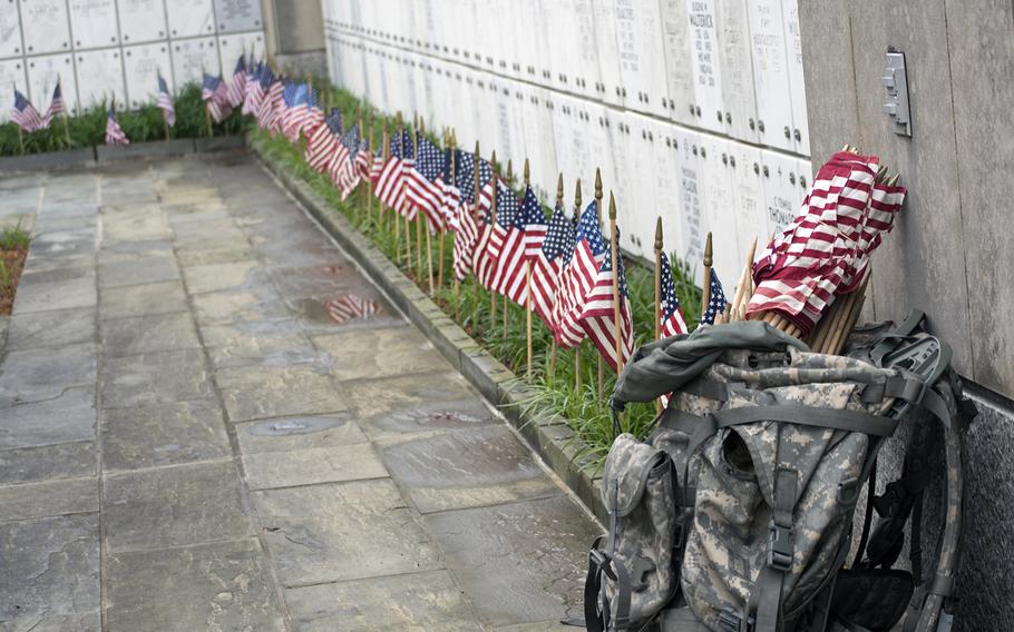 Members of The Old Guard looks more flags and more empty headstones toward the end of the Flags-In at Arlington National Cemetery on May 21, 2015, inside the columbarium. 
