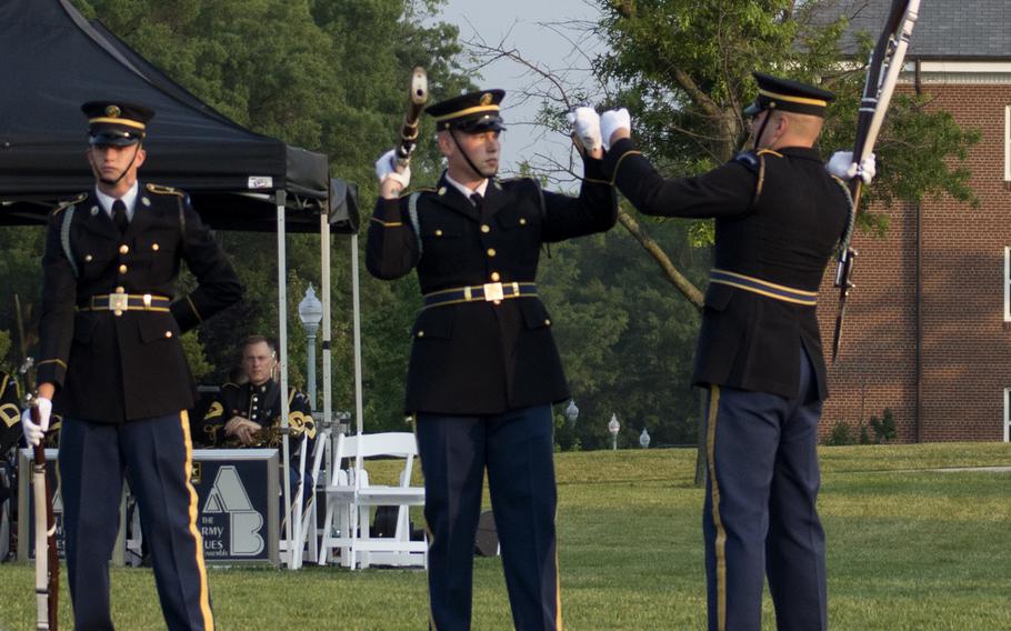 The Old Guard at Joint Base Myer-Henderson Hall in Arlington, Va., on June 10, 2015, as part of the Twilight Tattoo. Here, two members finish a fist bump.