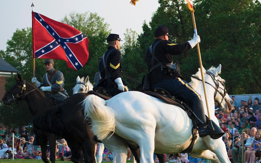 US Army soldiers dressed as Civil War re-enactors ride horses around a field at Joint Base Myer-Henderson Hell in Arlington, Va., on Wednesday, June 10, 2015, as part of the evening's Twilight Tattoo event. 