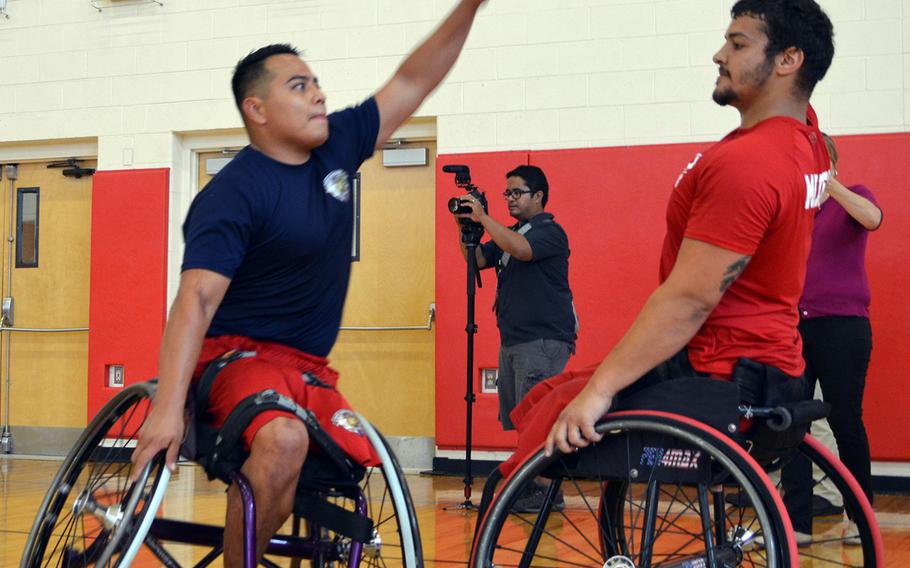 Wounded warriors Cpl. Marcus Chischilly, left and Matt Grashen scrimmage on June 18, 2015, at Quantico the day before the opening ceremony for the Wounded Warrior Games.
