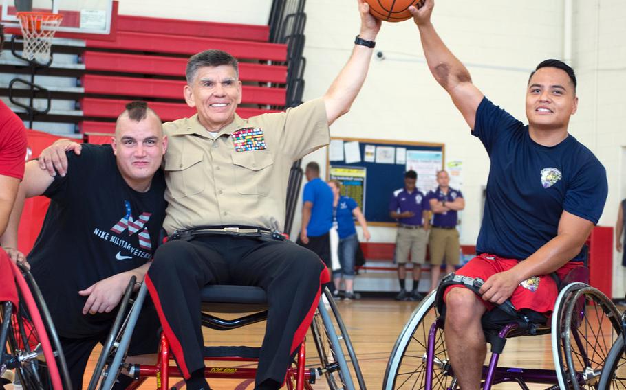 Wounded warriors Cpl. Marcus Chischilly, far right, and Marine veteran Zachary Blair pose with Gen. Juan Ayala after a scrimmage on June 18, 2015, at Quantico the day before the opening ceremony for the Wounded Warrior Games.