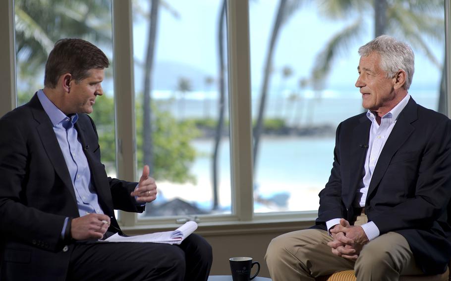 Peter Cook of Bloomberg Television interviews then-Secretary of Defense Chuck Hagel on April 3, 2014, in Honolulu.