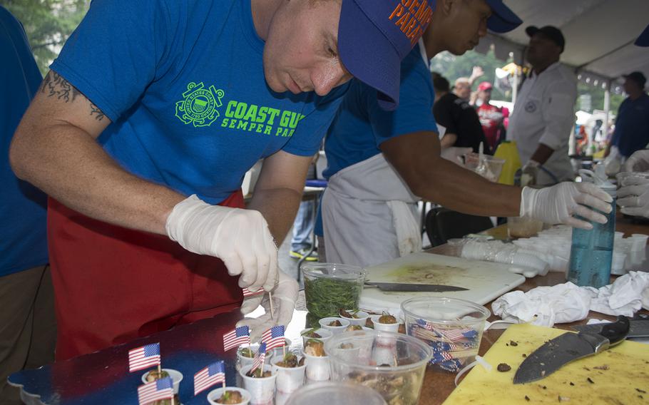 Dustin Webb, who served 15 years in the Coast Guard, puts the finishes touches on samples during the Military Chefs Cook-Off on June 27, 2015, in Washington, DC.