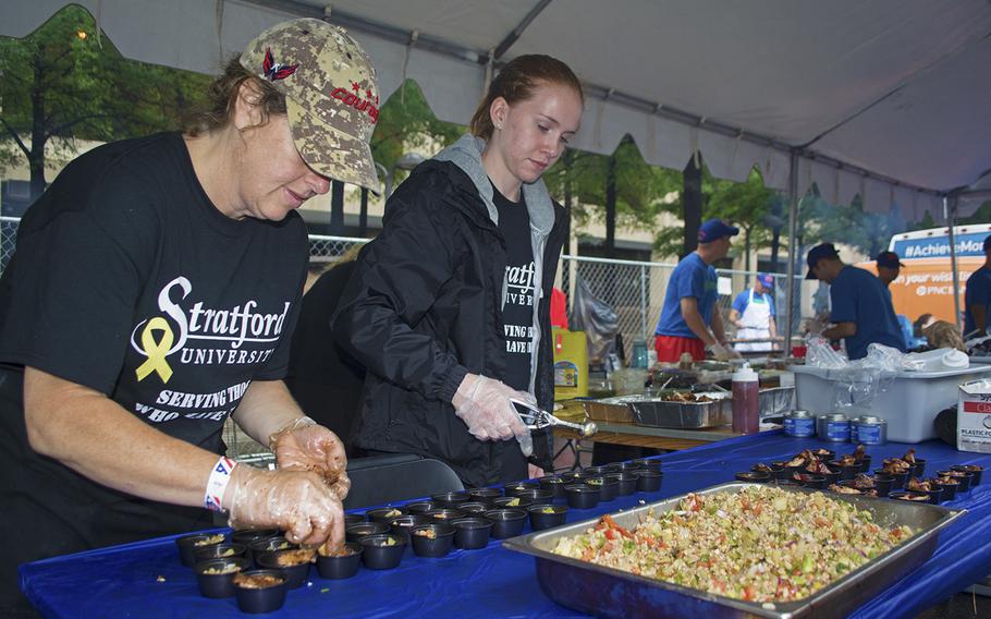 Two women under the US Air Force tent dole out samples during the Military Chefs Cook-Off on June 27, 2015.