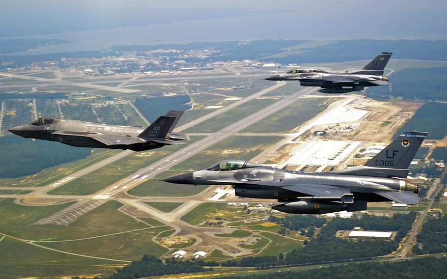 In a July, 2011 file photo, DOD's first F-35 Lightning II joint strike fighter soars past the 33rd Fighter Wing flightline with two F-16 Fighting Falcon chase aircraft before landing at its new home at Eglin Air Force Base, Fla.