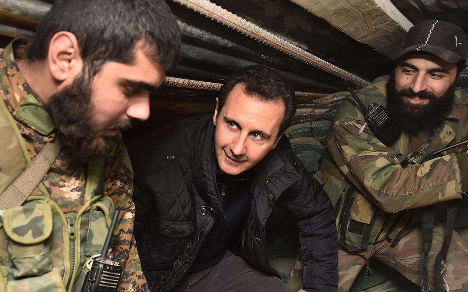 Syrian President Bashar Assad visits soldiers and officers at a military checkpoint near the area of Jobar, on the outskirts of Damascus, Syria, on Dec. 31, 2014.