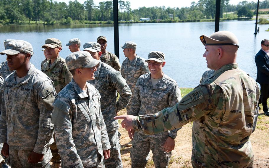 Family, friends and comrades of Ranger Class 08-15 gather to watch the Rangers in Action demonstration and "pin" their loved ones with the coveted Ranger Tab at Victory Pond on Aug. 21, 2015. 