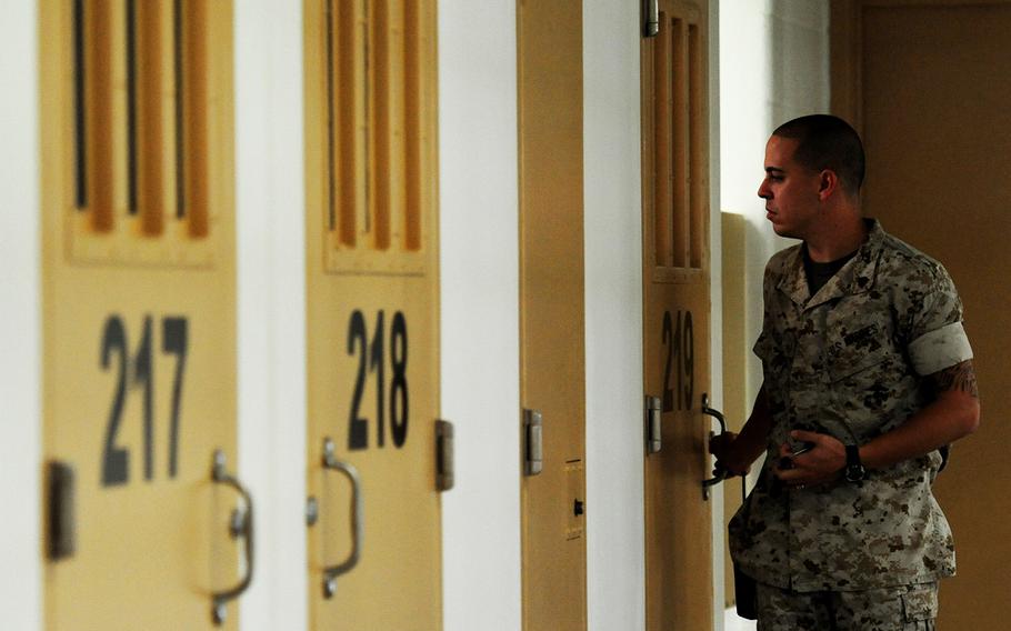 Marine Sergeant Xavier Reyes patrols a then-new housing unit inside the Naval Consolidated Brig Charleston at Joint Base Charleston-Weapons Station, S.C., Sept. 20, 2011.