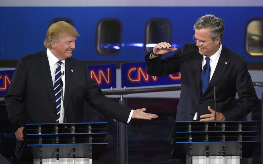 GOP presidential candidate and businessman Donald Trump, left, and former Florida Gov. Jeb Bush slap hands near the finish of the CNN Republican presidential debate at the Ronald Reagan Presidential Library and Museum on Wednesday, Sept. 16, 2015, in Simi Valley, Calif.