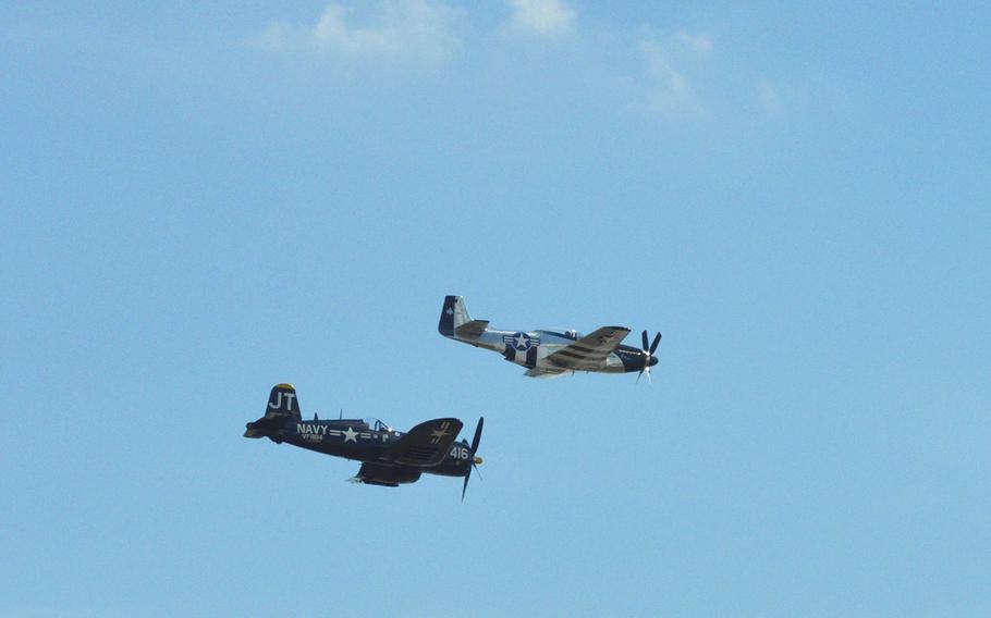 The F-4U Corsair "Korean War Hero," flown by Jim "Torc" Tobul, and a P-51 fly over the crowd at the 2015 Joint Base Andrews Air Show. Over 10,000 people attended the event.