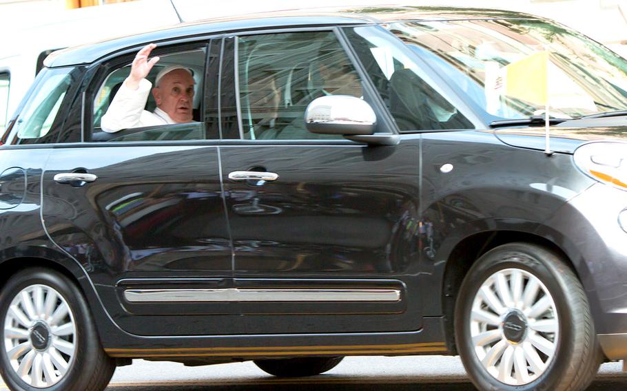 Pope Francis waves as he leaves St. Patrick's Church in Washington, D.C., Thursday. Earlier, the pontiff had addressed a joint session of Congress.