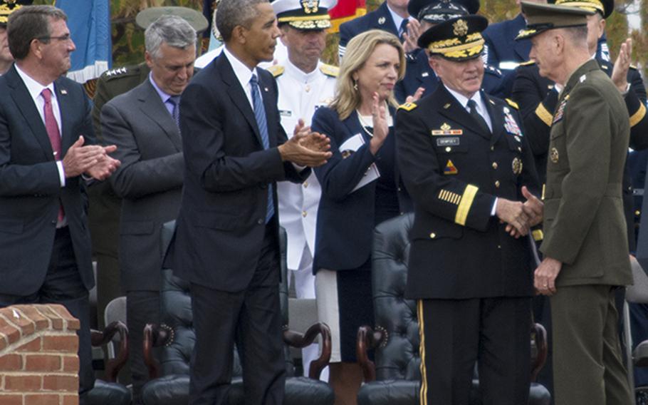 Retiring Chairman of the Joint Chiefs of Staff, Gen. Martin Dempsey, shakes hands with his successor, Gen. Joseph Dunford Jr., as President Barack Obama, Secretary of Defense Ash Carter and other dignitaries applaud during Dempsey's farewell ceremony at Joint Base Myer-Henderson Hall, Va., Sept. 25, 2015.